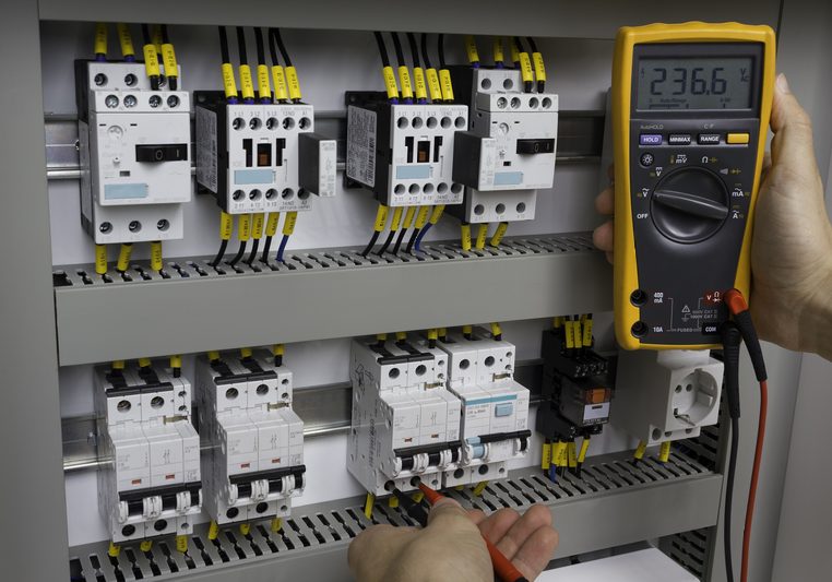 Electrician at work electrical cabinet